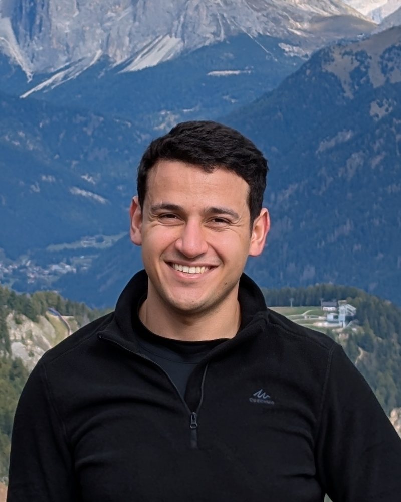 Portrait of Osama Salem smiling in front of mountains